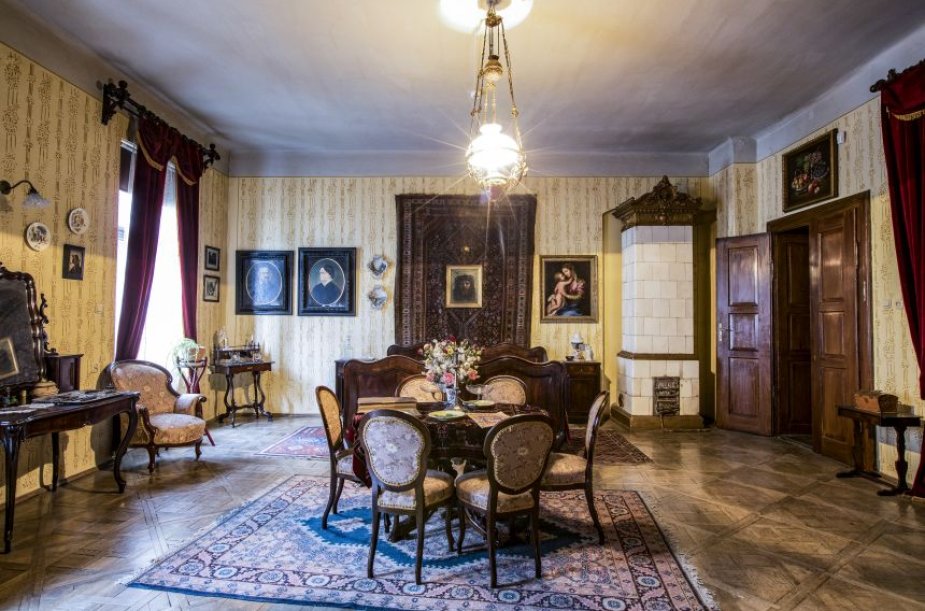 A large room with a table and chairs in the middle